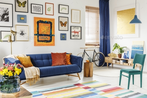 Spacious living room interior with a blanket and orange pillows